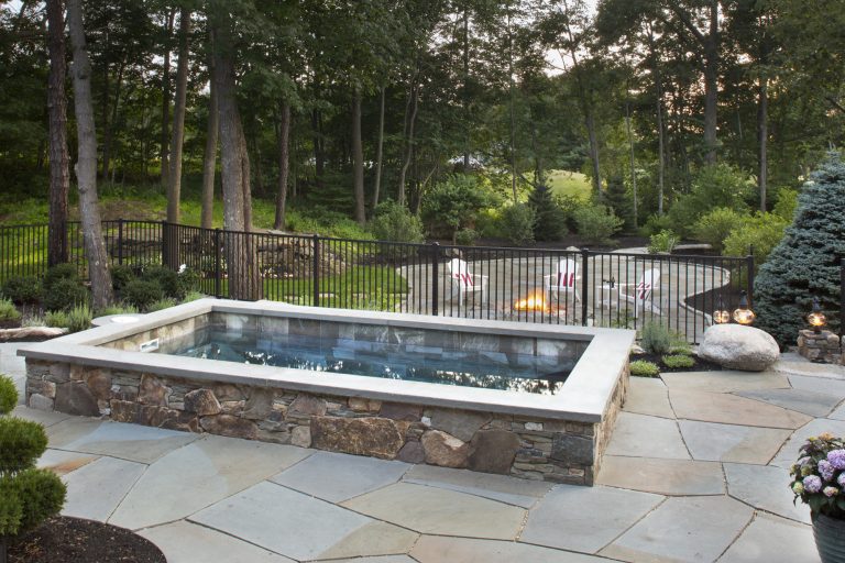 Finished project, Soake Pool surrounded by lovely stone work and bluestone patio overlooking gas fire pit area. A truly stunning backyard retreat! Photo Credit: Tim Murphy, Foto Imagery by Soake Pools | Pool design | Pool Contracting | Swimming Pool Ideas | Swimming Pool Design Ideas