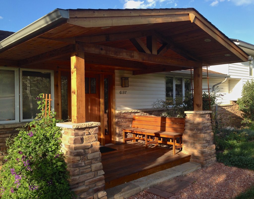 Front porch addition with stone columns, mahogany deck and benches, and timber framing. Note the stone veneer that matches the columns and covers the original brick "apron". by User | Outdoor Photos | Porch | Landscaping | Landscape Design | Outdoor Living Space | Porch Design Ideas | Outdoor Living Space Ideas | Backyard Design