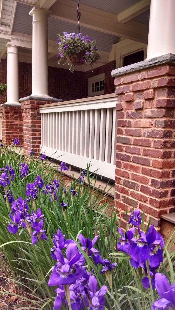 Front porch detail of columns and railing. Photo Credit: N. Leonard