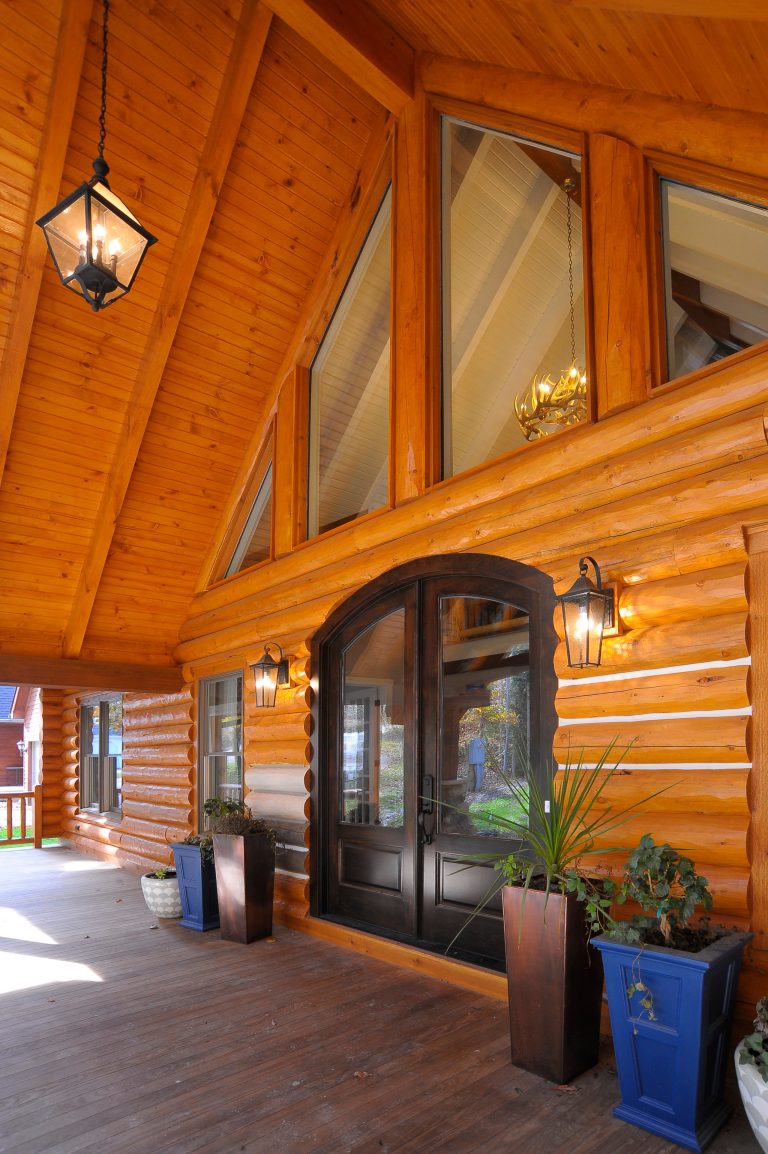 Front porch featuring a double door entry with black light fixtures and large trapezoid windows.