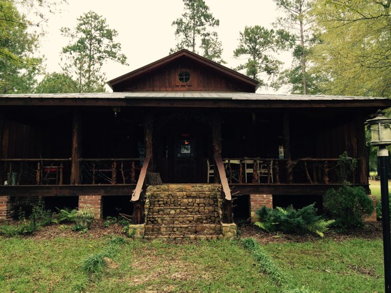 Front porch - front entrance to hunting lodge. Cedar tree posts,cedar slab hand rails,cedar branch balusters, and river stone steps. Designed and built by Bobby Huellemeier, elemental thought by elemental thought | Outdoor Photos | Porch | Landscaping | Landscape Design | Outdoor Living Space | Porch Design Ideas | Outdoor Living Space Ideas | Backyard Design