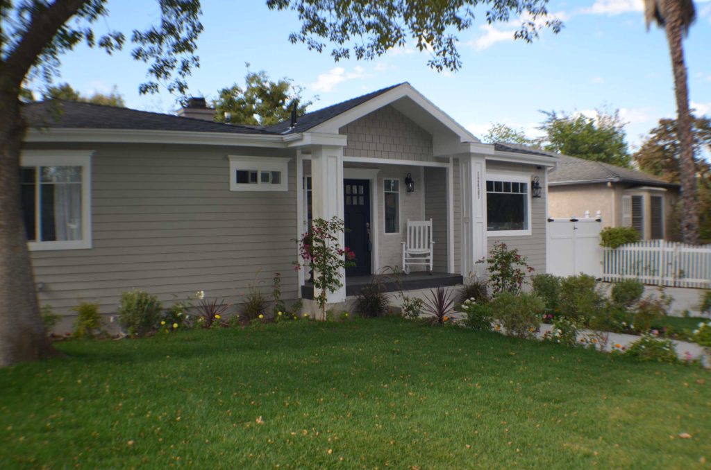 Front porch of the remodeled house construction in Milbank which included installation of custom wood frame, garden pathway, vinyl siding, white porch columns and landscaping. by Landmark Construction Crew | Outdoor Photos | Porch | Landscaping | Landscape Design | Outdoor Living Space | Porch Design Ideas | Outdoor Living Space Ideas | Backyard Design
