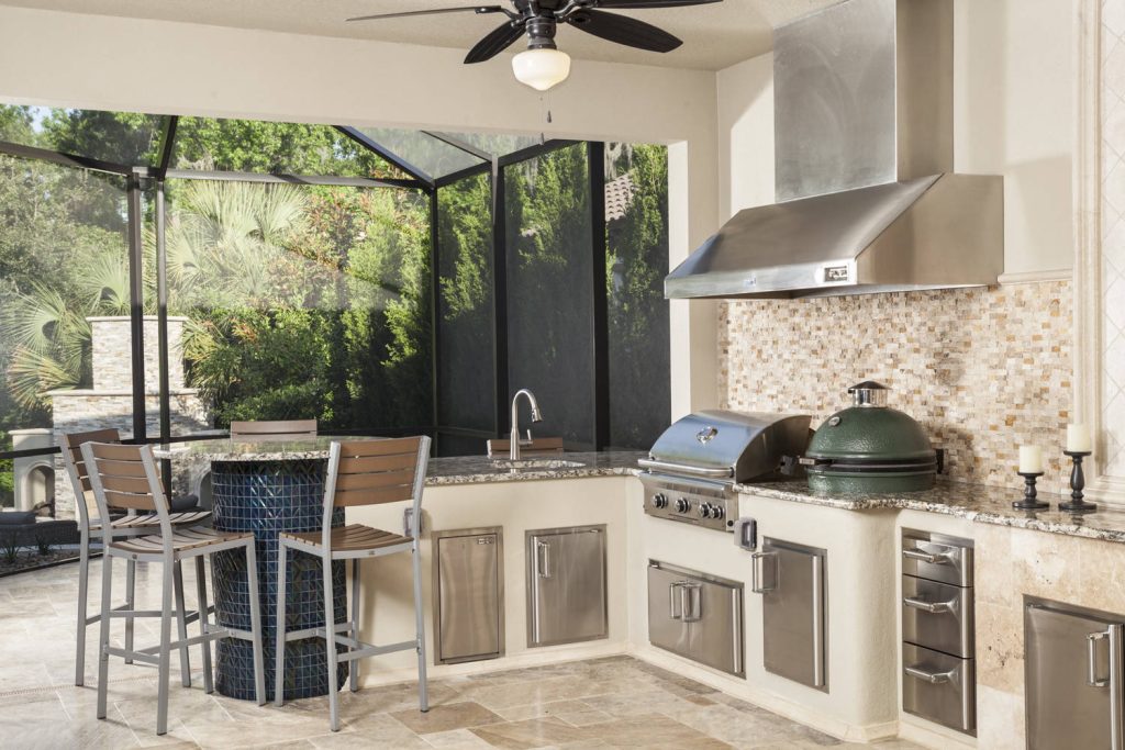 Fully equipped kitchen accommodates any gathering with gas grill by Fire Magic and ceramic kamado-style charcoal grill by Big Green Egg. The custom high dining table completes the kitchenscape.