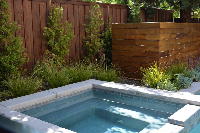 Given the limited space, the hot tub is designed to fit in a corner of the pool. Hand placed tiles and built in benches - with enough room for the whole family!