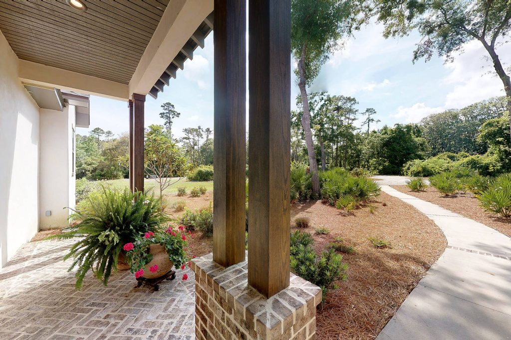 Gorgeous wood beams double-line the front entryway, Mosstown Brick accents are placed along the porch floor in a chevron pattern, and beadboard wood ceiling provides the perfect accent at the front porch. by Georgia Coast Design & Construction | Outdoor Photos | Porch | Landscaping | Landscape Design | Outdoor Living Space | Porch Design Ideas | Outdoor Living Space Ideas | Backyard Design
