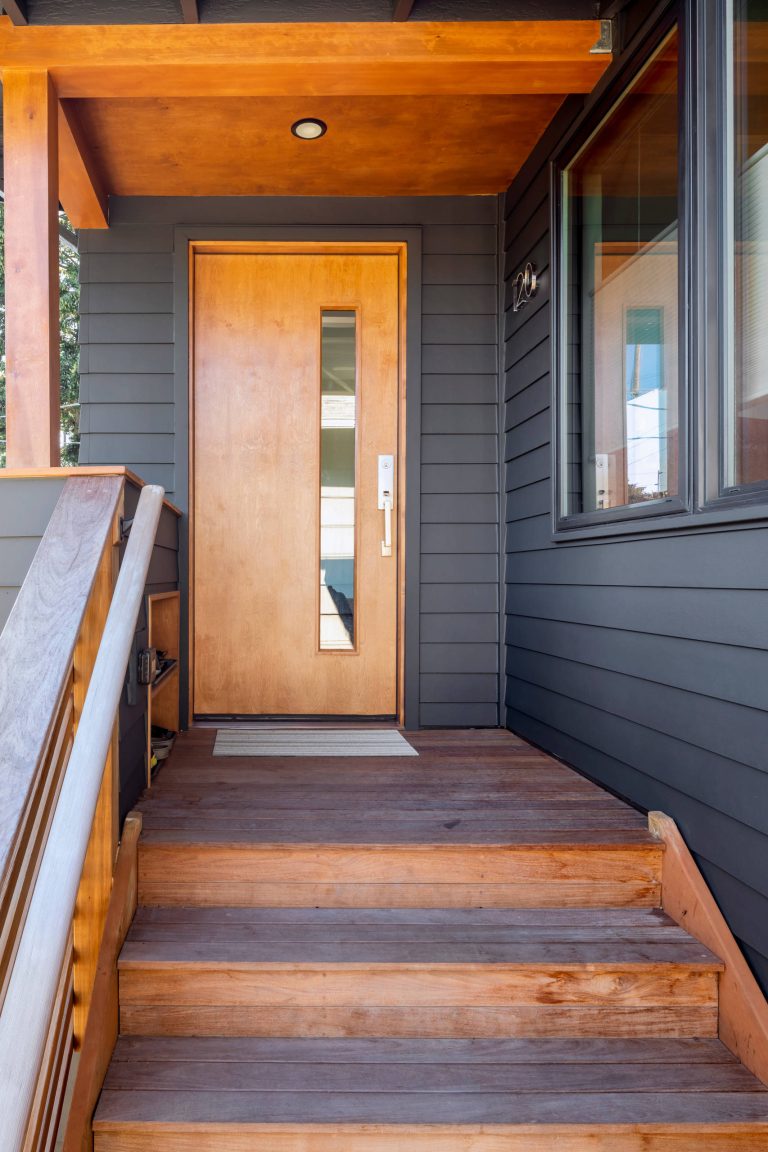 Gray front porch with wood accents and door. © Cindy Apple Photography