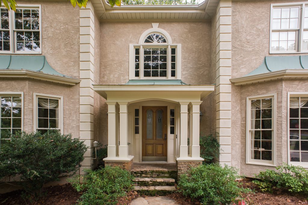 Handsome portico adds dramatic curb appeal to this stucoo home. The roof line mimics design and slope of adjacent bay windows. Stone piers support square columns. by Georgia Front Porch | Outdoor Photos | Porch | Landscaping | Landscape Design | Outdoor Living Space | Porch Design Ideas | Outdoor Living Space Ideas | Backyard Design