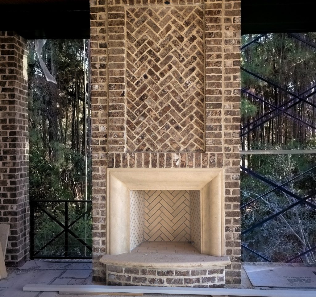 Herringbone fire box with caststone surround and herringbone brick inset.