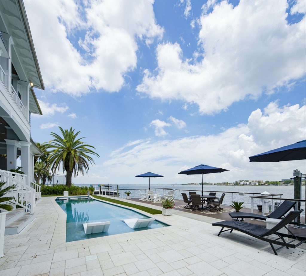 Hot tub - large coastal backyard concrete paver and rectangular lap hot tub idea in Tampa