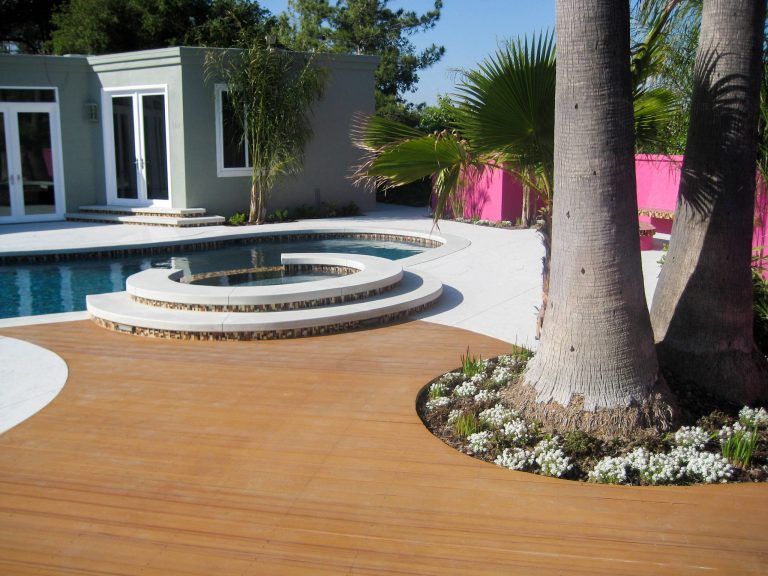 Hot tub - large contemporary backyard stamped concrete and custom-shaped natural hot tub idea in Los Angeles