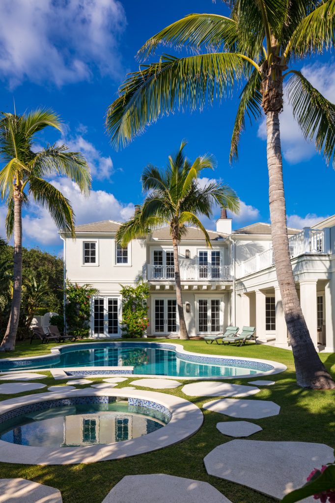 Hot tub - large mediterranean backyard custom-shaped hot tub idea in Miami