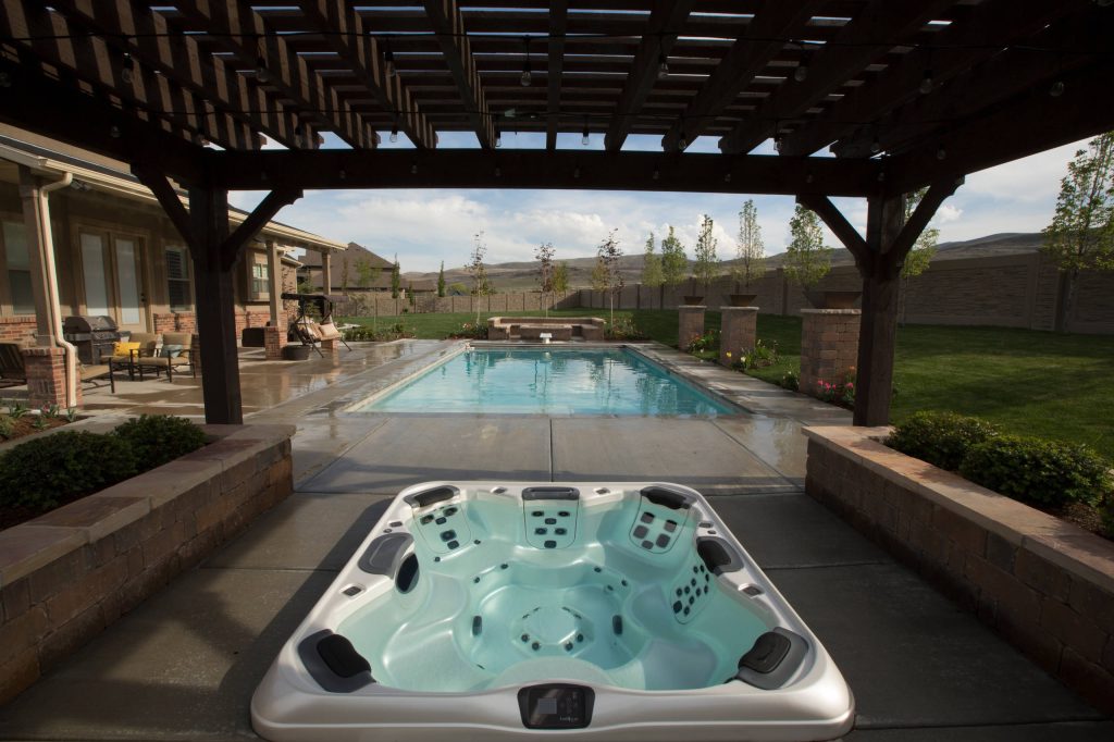 Hot tub - large traditional backyard concrete and rectangular lap hot tub idea in Salt Lake City