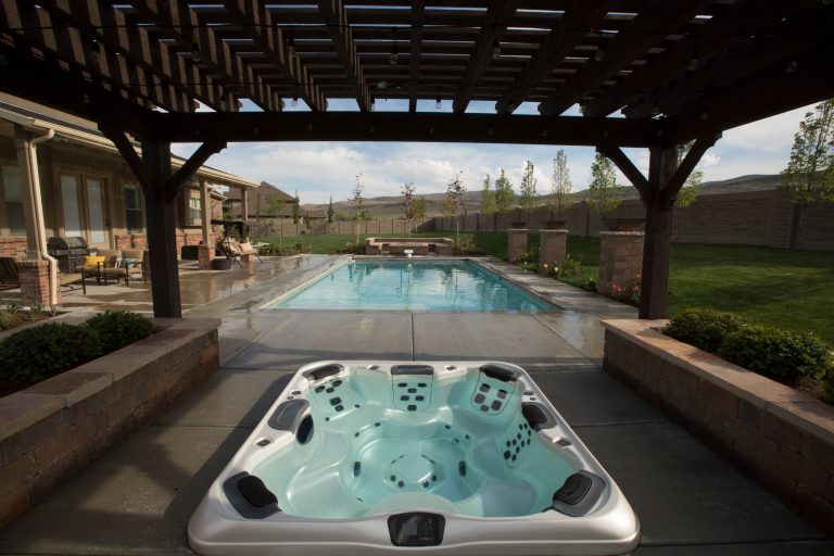 Hot tub - large traditional backyard concrete and rectangular lap hot tub idea in Salt Lake City