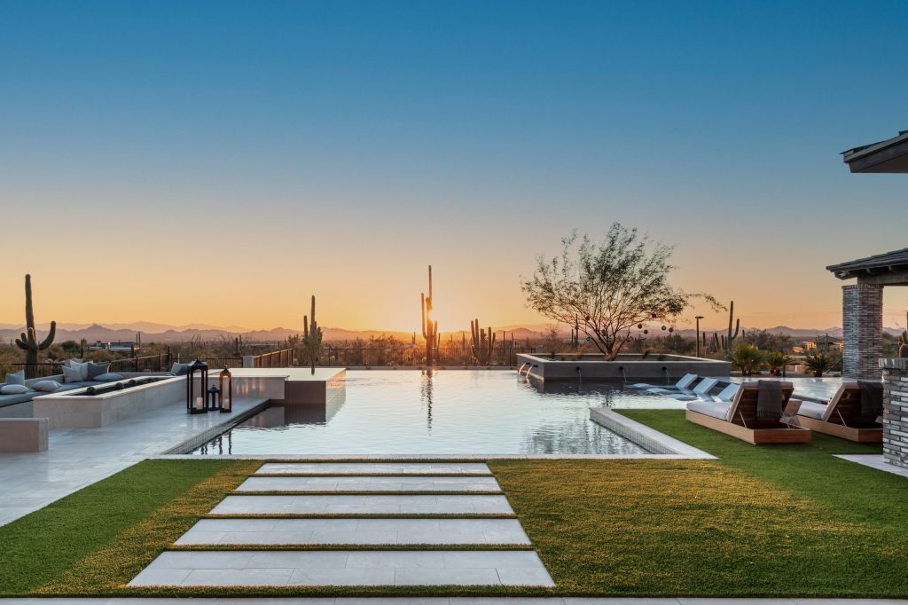 Hot tub - large transitional backyard stone and rectangular infinity hot tub idea in Phoenix