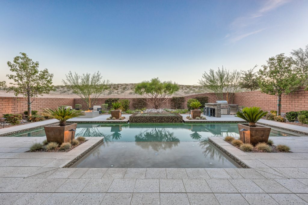 Hot tub - large tropical backyard stone and rectangular lap hot tub idea in Las Vegas