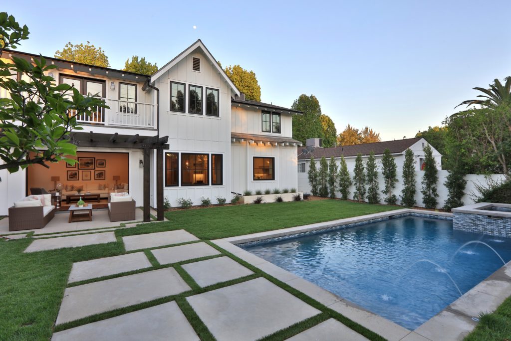 Hot tub - mid-sized farmhouse backyard rectangular and concrete paver hot tub idea in Los Angeles