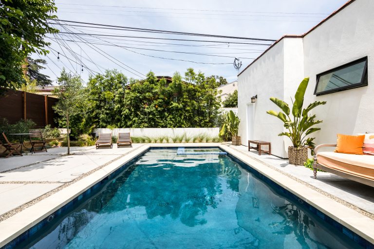 Hot tub - mid-sized mediterranean backyard concrete and rectangular hot tub idea in Los Angeles