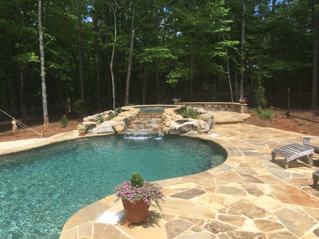 Hot tub - mid-sized rustic backyard stone and custom-shaped natural hot tub idea in Atlanta
