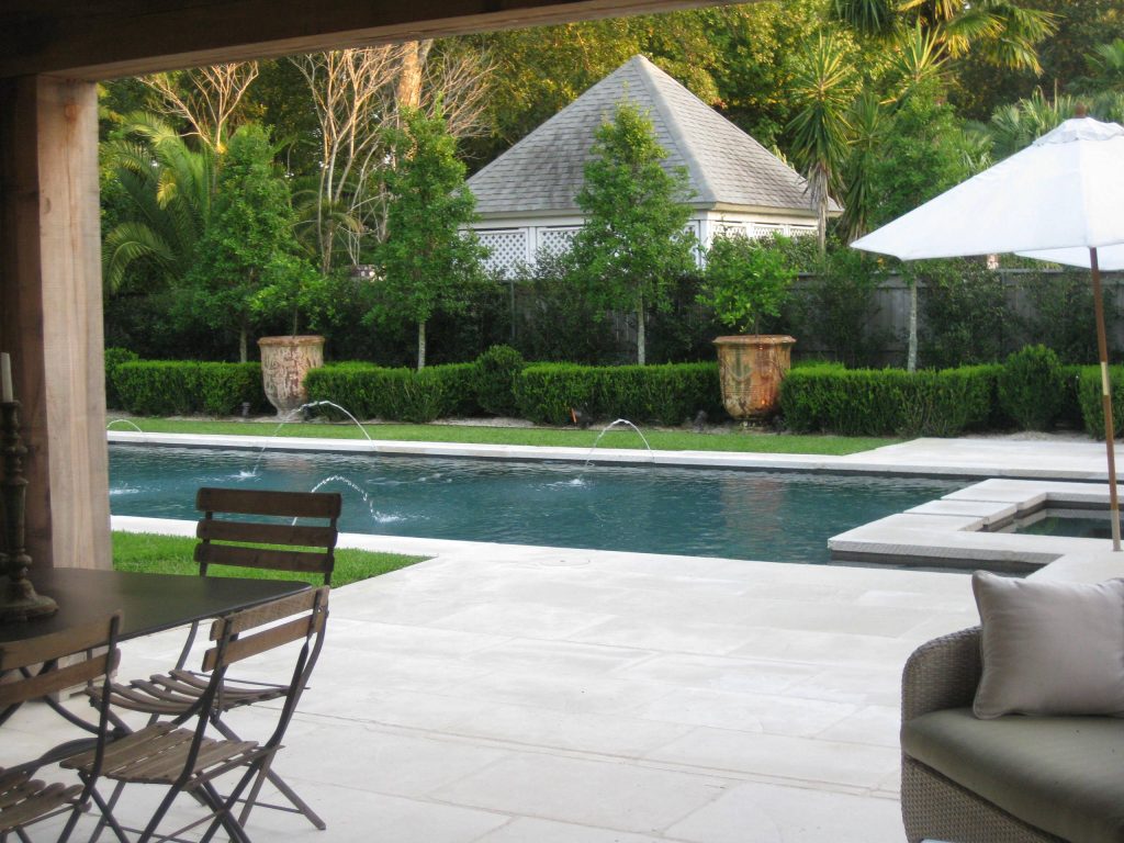 Hot tub - mid-sized transitional backyard stone and rectangular natural hot tub idea in New Orleans