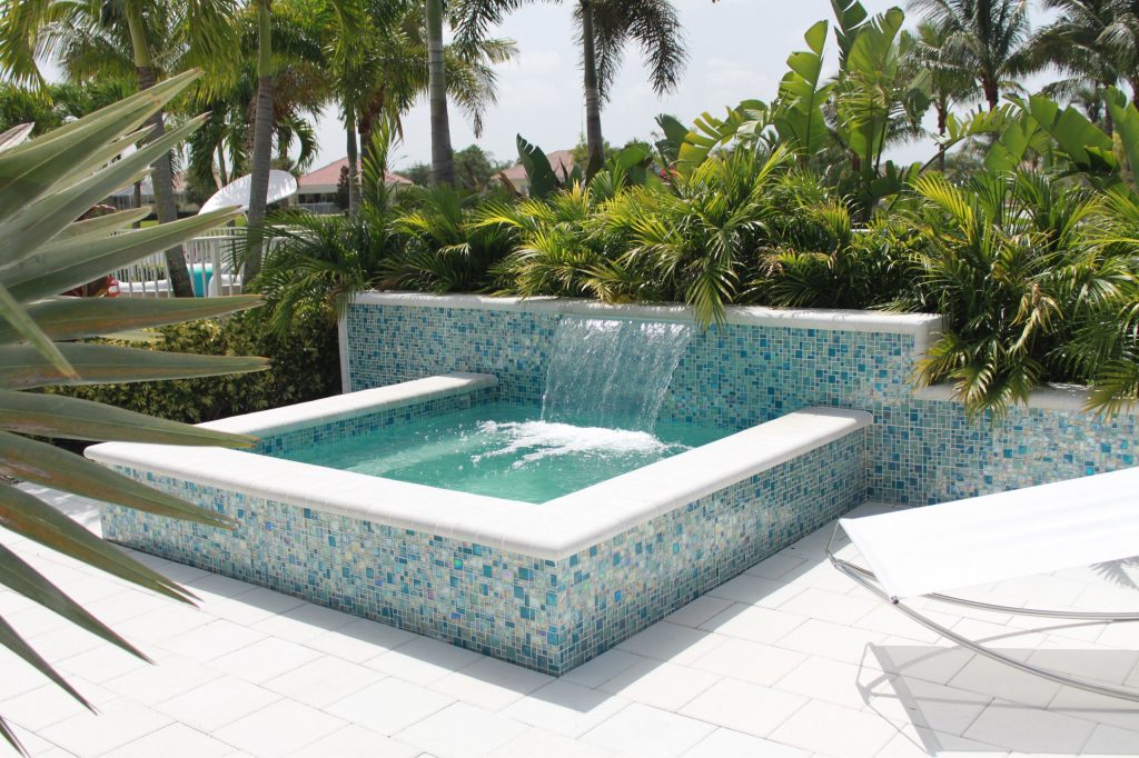 Hot tub - small modern backyard concrete paver and rectangular aboveground hot tub idea in Miami