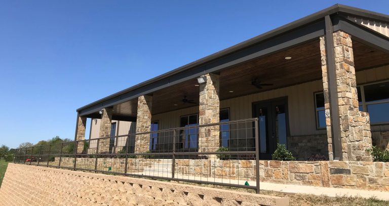 Huge country backyard concrete patio kitchen photo in Dallas with a roof extension