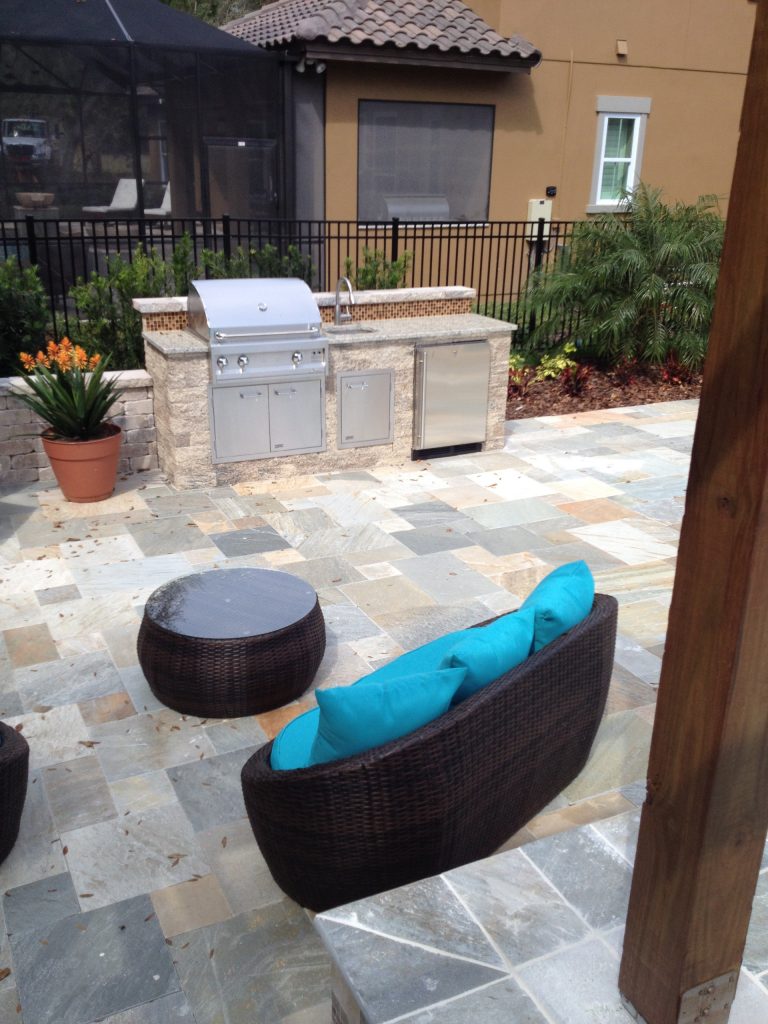 Huge elegant backyard tile patio kitchen photo in Tampa with a pergola