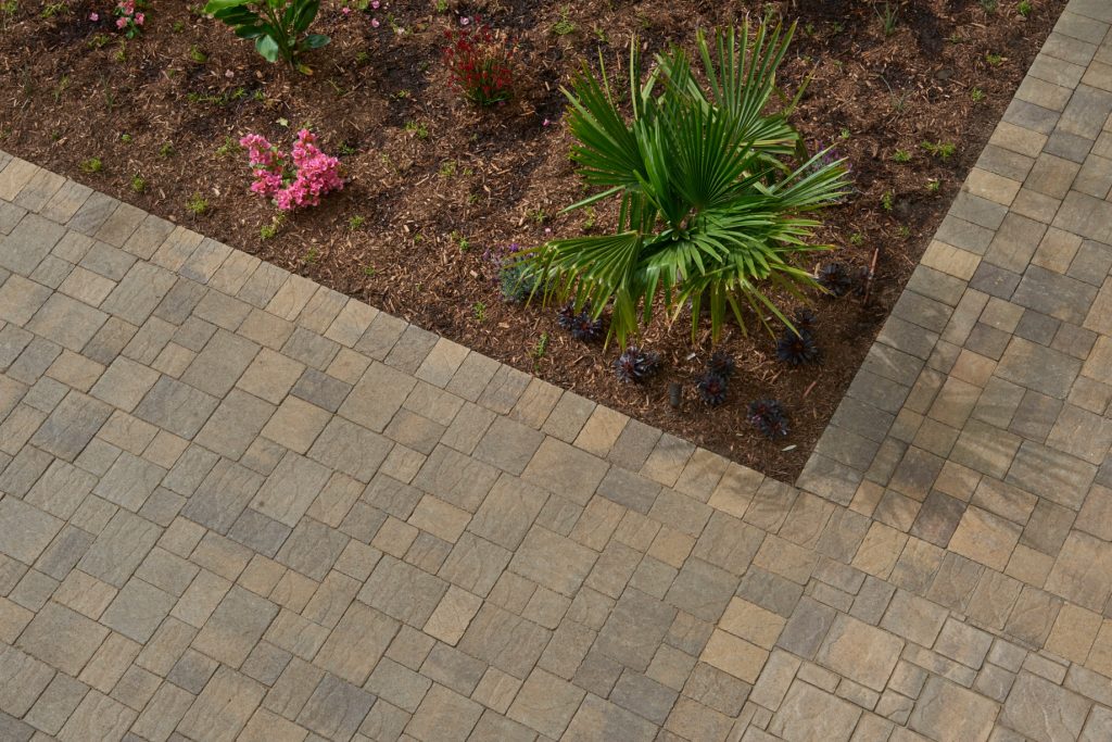 Huge island style backyard brick patio kitchen photo in Los Angeles with no cover