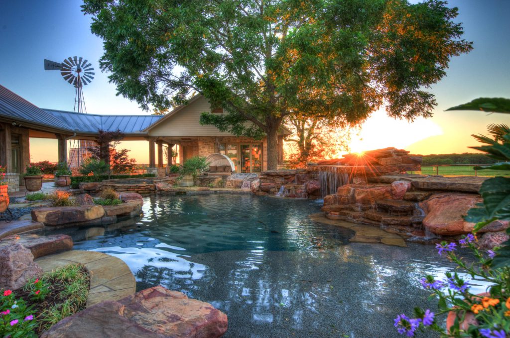 Huge island style backyard stone and custom-shaped natural hot tub photo in Austin