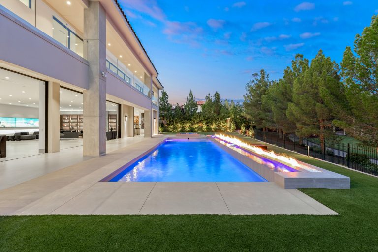 Huge minimalist backyard custom-shaped pool landscaping photo in Las Vegas
