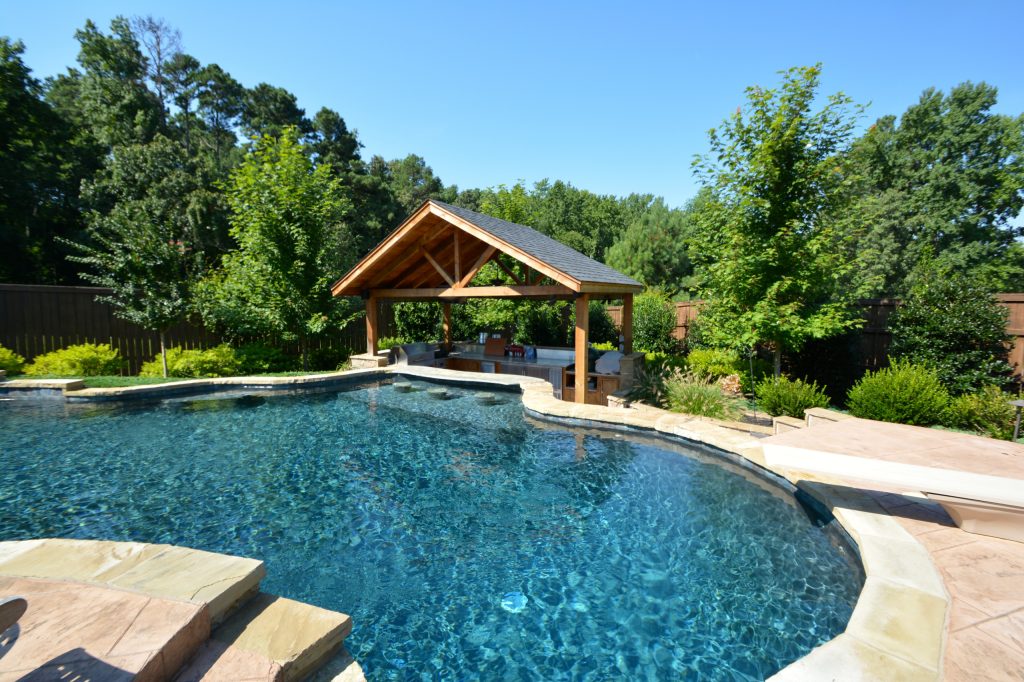 Huge mountain style backyard custom-shaped and stone lap pool fountain photo in Little Rock