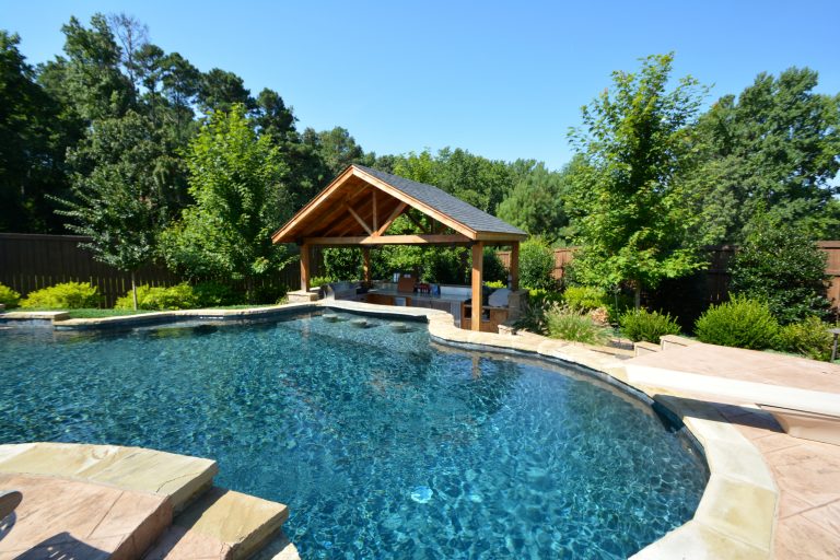 Huge mountain style backyard custom-shaped and stone lap pool fountain photo in Little Rock