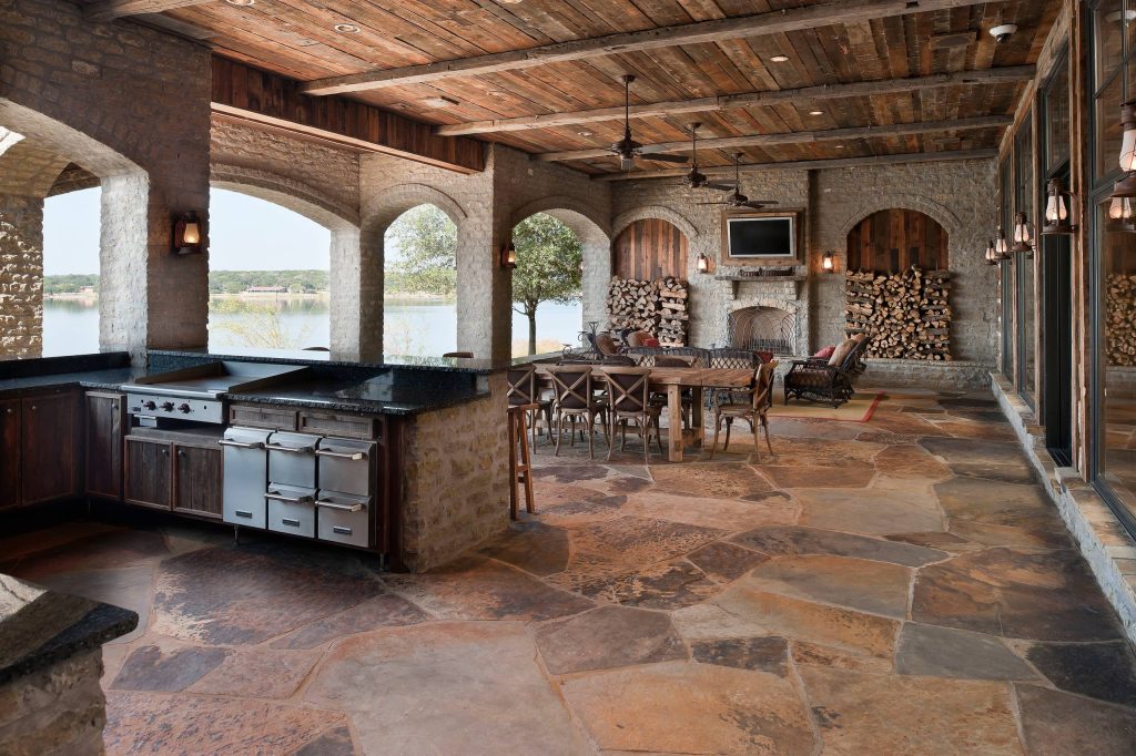 Huge mountain style backyard tile patio kitchen photo in Dallas with a roof extension