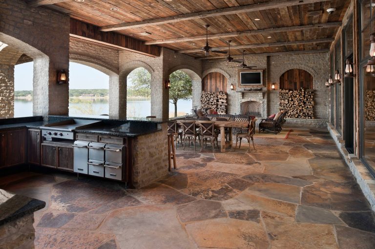 Huge mountain style backyard tile patio kitchen photo in Dallas with a roof extension