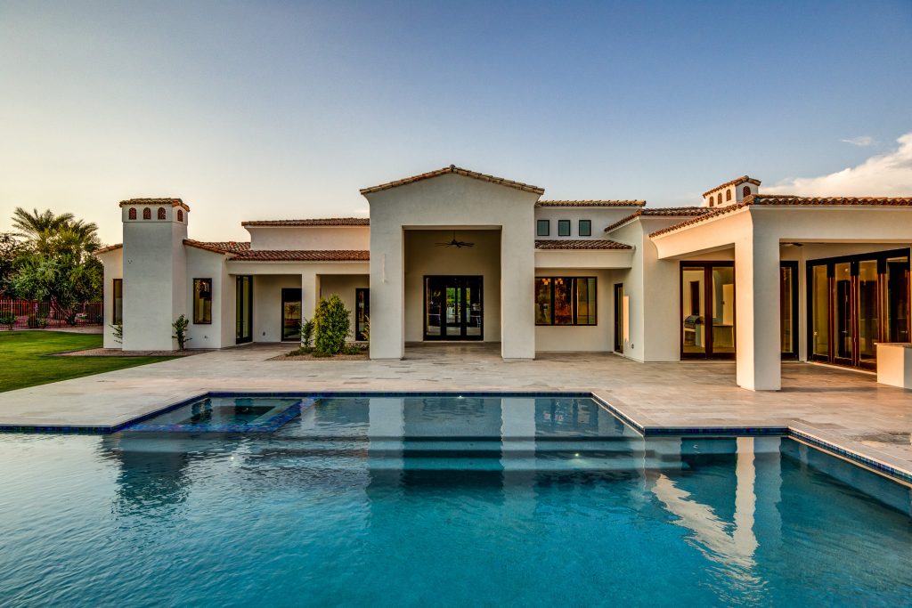 Huge transitional backyard tile and rectangular infinity hot tub photo in Phoenix