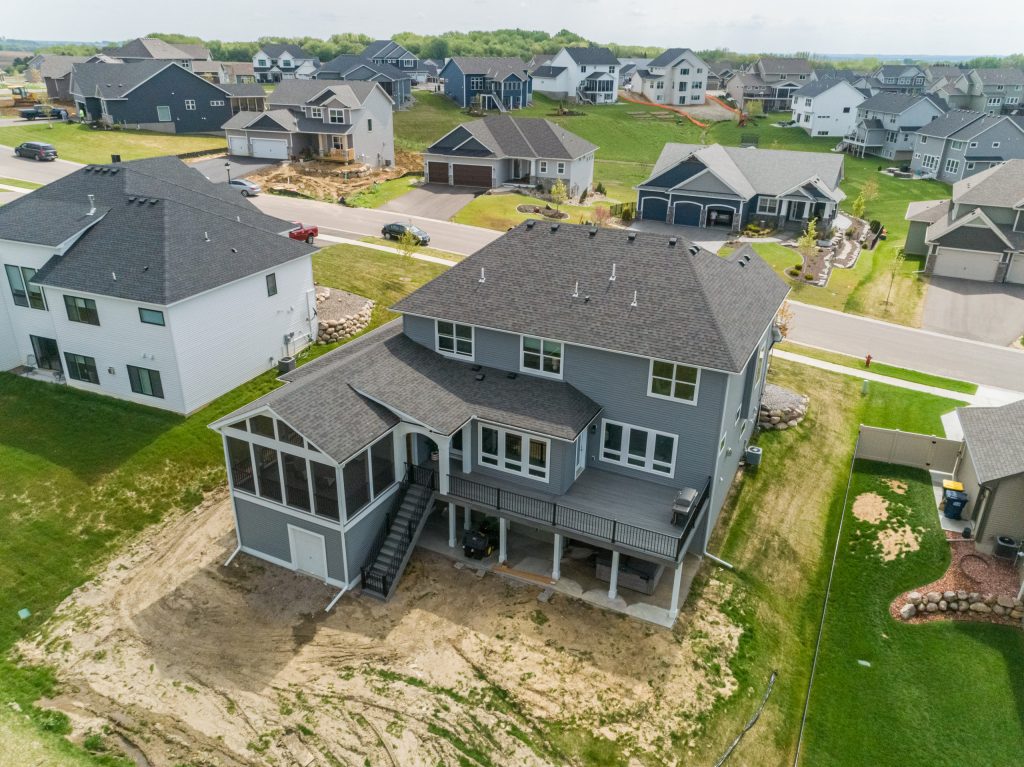 Huge transitional screened-in and metal railing back porch photo in Minneapolis with decking and a roof extension by Titus Contracting | Outdoor Photos | Porch | Landscaping | Landscape Design | Outdoor Living Space | Porch Design Ideas | Outdoor Living Space Ideas | Backyard Design