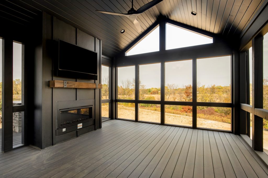 Huge transitional screened-in and wood railing back porch idea in Minneapolis with decking and a roof extension by Homes by Tradition | Outdoor Photos | Porch | Landscaping | Landscape Design | Outdoor Living Space | Porch Design Ideas | Outdoor Living Space Ideas | Backyard Design