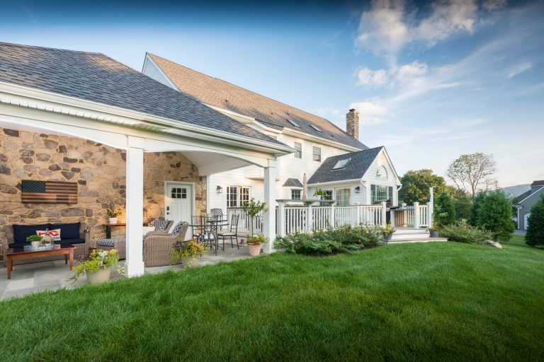 Huge trendy stone back porch photo in Philadelphia with a roof extension by Chestnut Hill Landscape Contractors | Outdoor Photos | Porch | Landscaping | Landscape Design | Outdoor Living Space | Porch Design Ideas | Outdoor Living Space Ideas | Backyard Design
