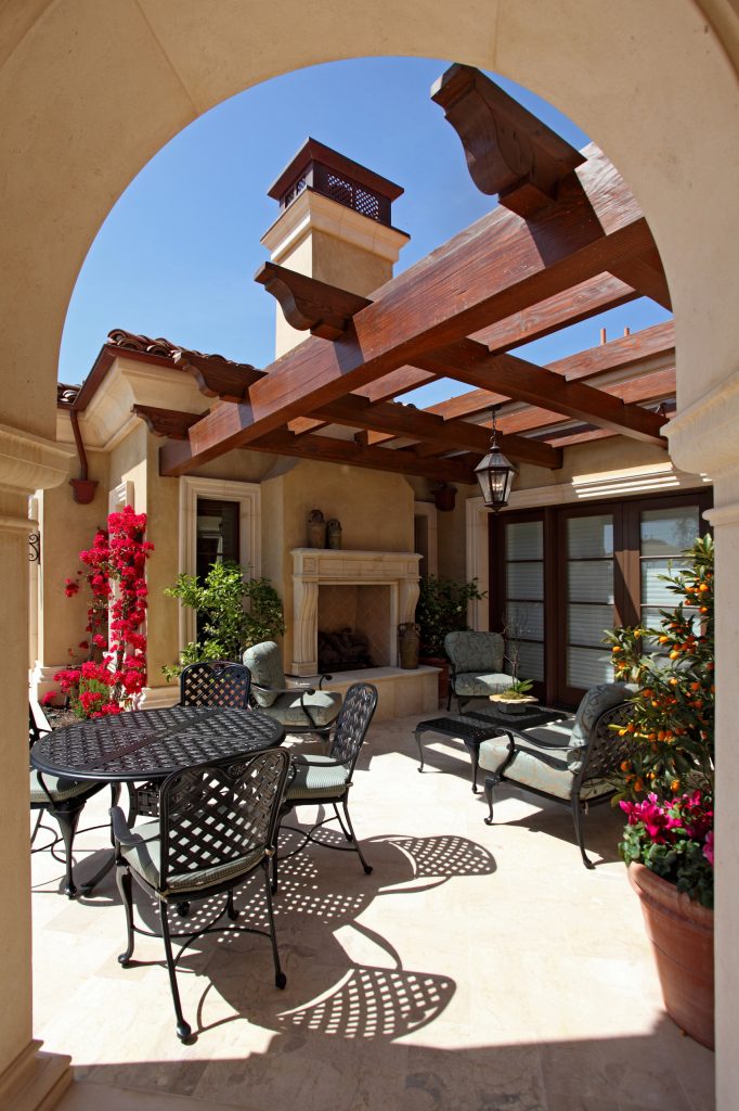 Huge tuscan backyard stone patio photo in Orange County with a fireplace and a roof extension by Pelican Developers | Outdoor Photos | Porch | Landscaping | Landscape Design | Outdoor Living Space | Porch Design Ideas | Outdoor Living Space Ideas | Backyard Design