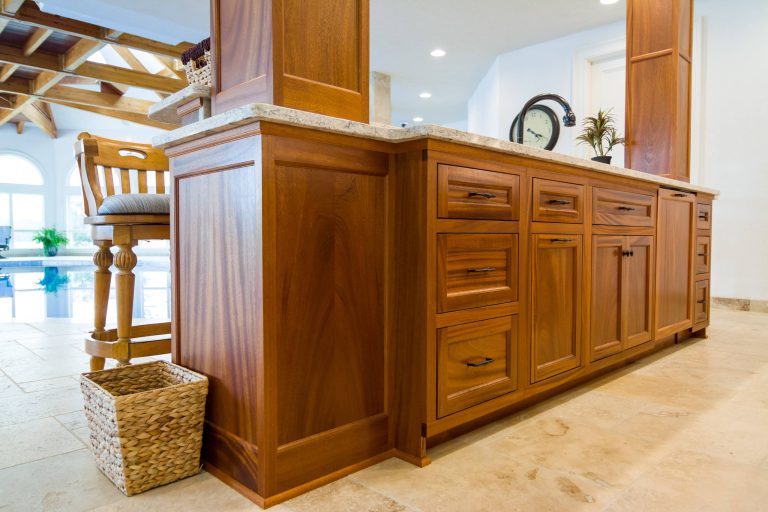 In-house built custom, mahogany cabinetry with quartz counter-top. Wet bar overlooks indoor swimming pool.