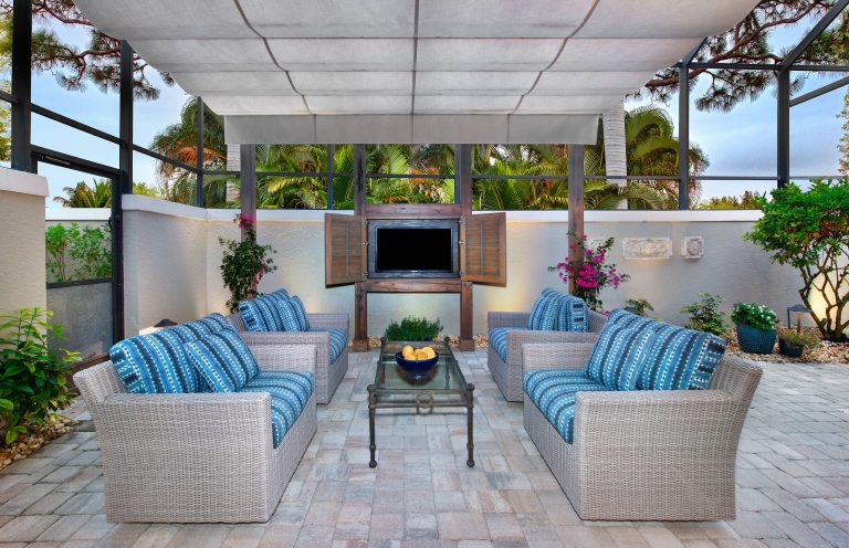 In the seating area, Progressive Design-Build installed a new weatherproof outdoor TV console made of the same Cypress wood used in the pergola, for a seamless coordinated look.