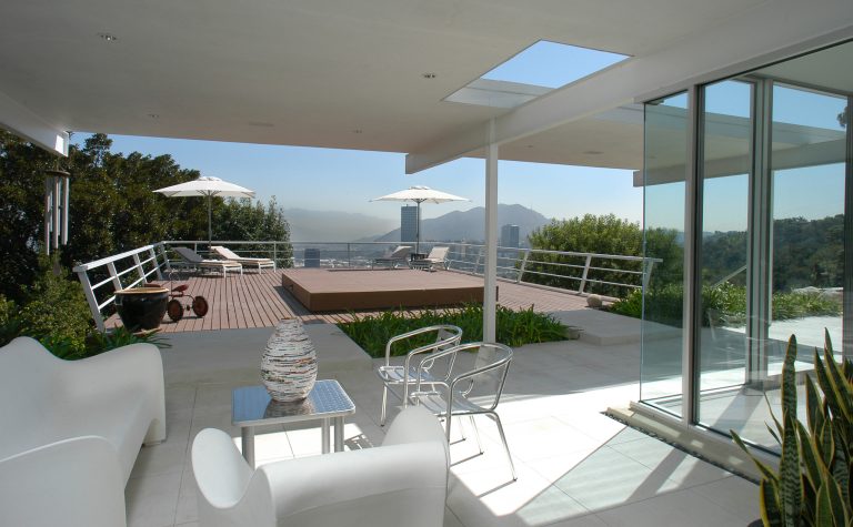 Indoor-outdoor living space with twin bridges to cantilevered wood deck.