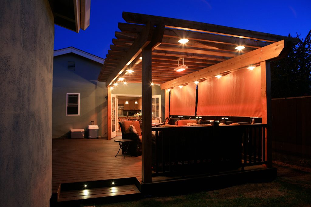 Indoor - outdoor living with a custom trex deck and redwood trellis, custom lighting and heat.