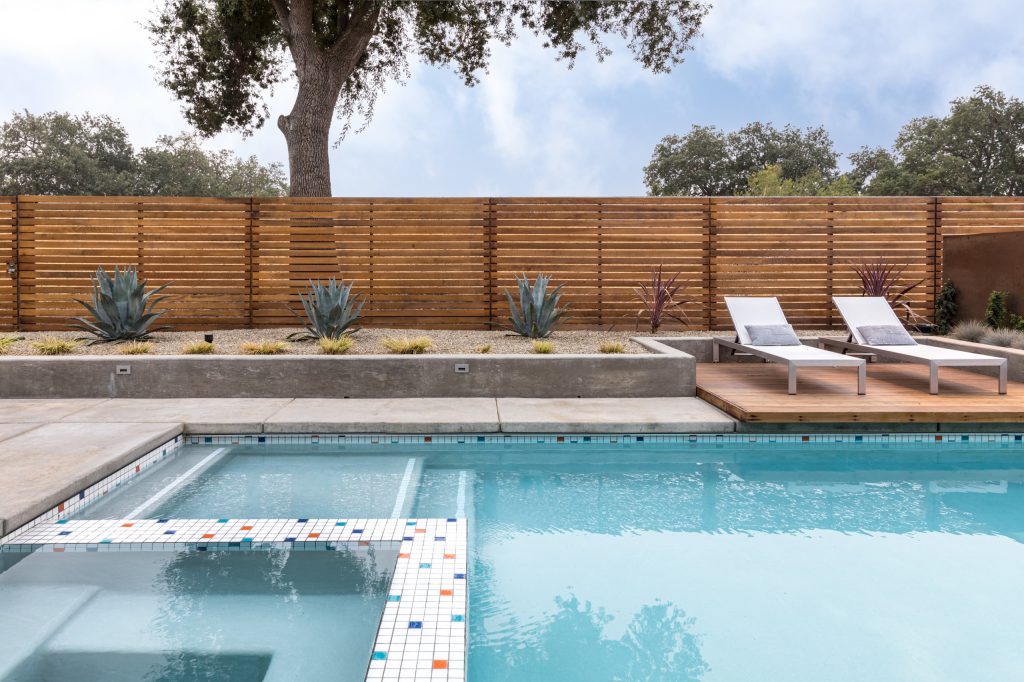 Inspiration for a 1950s backyard rectangular hot tub remodel in Sacramento with decking