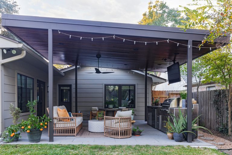 Inspiration for a 1950s backyard tile patio kitchen remodel in Houston with a pergola