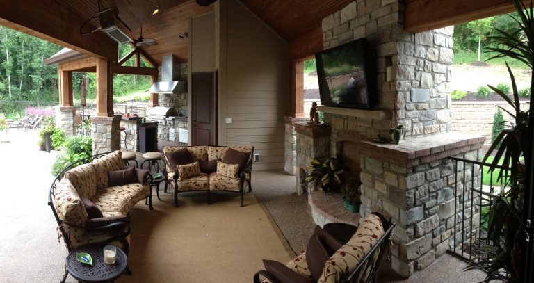 Inspiration for a backyard concrete paver patio kitchen remodel in St Louis with a roof extension
