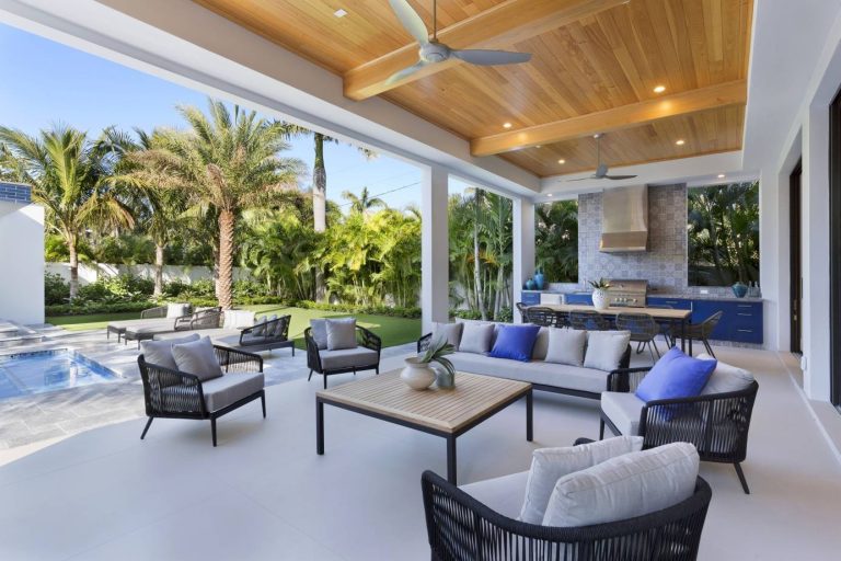 Inspiration for a coastal backyard patio kitchen remodel in Miami with a roof extension
