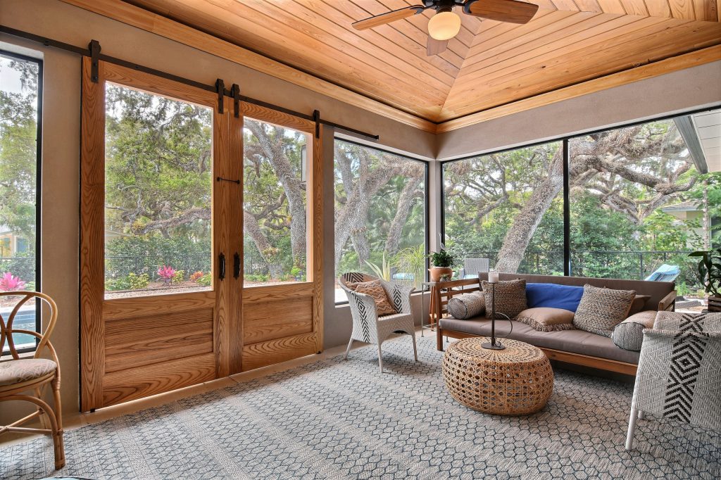 Inspiration for a coastal concrete screened-in back porch remodel in Miami with a roof extension by Builders East Inc. | Outdoor Photos | Porch | Landscaping | Landscape Design | Outdoor Living Space | Porch Design Ideas | Outdoor Living Space Ideas | Backyard Design