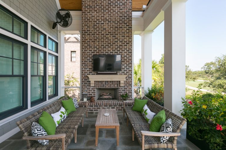Inspiration for a coastal porch remodel in Charleston with a fireplace and a roof extension by Translations Design Studio, LLC | Outdoor Photos | Porch | Landscaping | Landscape Design | Outdoor Living Space | Porch Design Ideas | Outdoor Living Space Ideas | Backyard Design