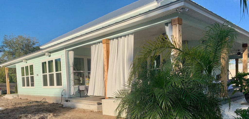 Inspiration for a concrete porch remodel in Jacksonville with a roof extension by Kurco Construction, Inc | Outdoor Photos | Porch | Landscaping | Landscape Design | Outdoor Living Space | Porch Design Ideas | Outdoor Living Space Ideas | Backyard Design