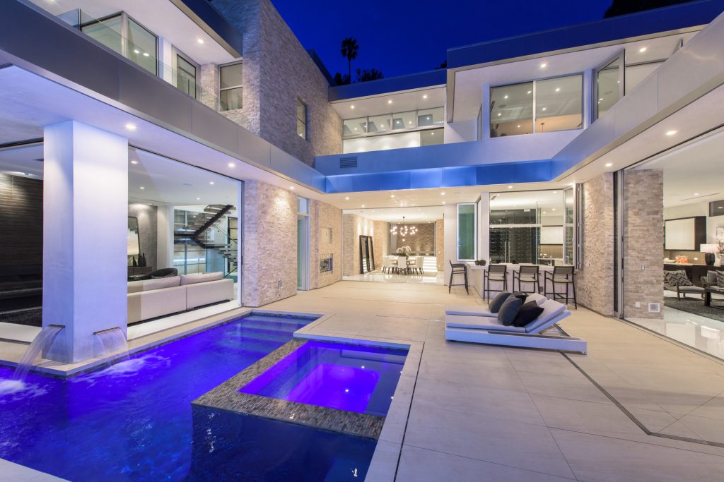 Inspiration for a contemporary backyard concrete and rectangular infinity pool remodel in Los Angeles